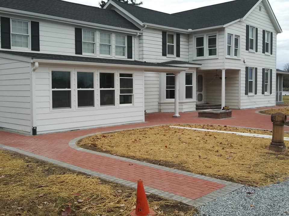 A freshly completed home with new grass seeded in the front yard.